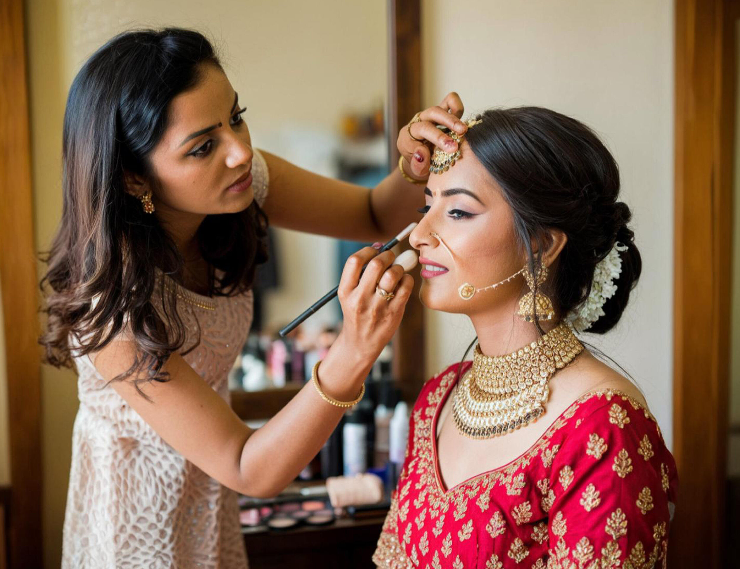  Woman getting bridal look makeup by proffesoional makeup artist for wedding